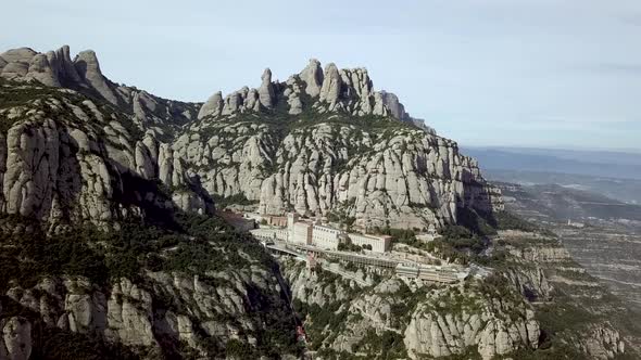 Aerial Montserrat Mountain Range With Santa Maria Abbey Monastery In Spain alt