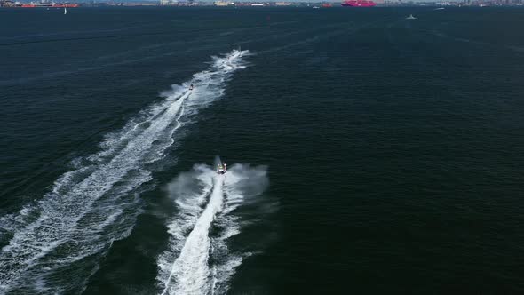aerial chase of a group of jet ski riders on the waters between Brooklyn & Staten Island, New York,i alt