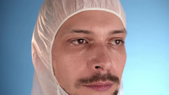Caucasian Bearded Man in White Protective Suit Take Off Medical Mask From Face