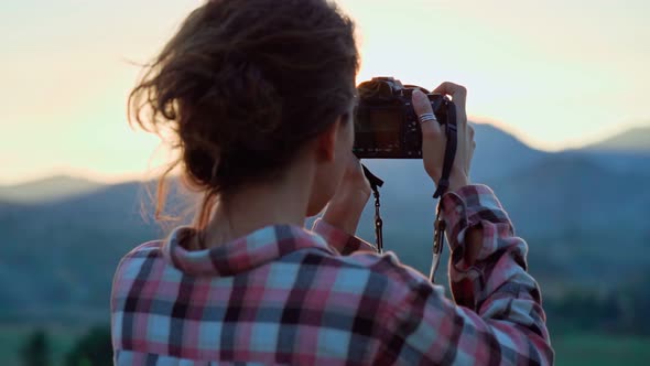 Photographer Taking Pictures of Mountain Landscape at Sunset alt