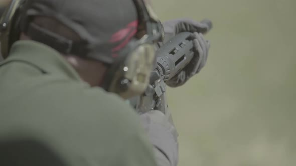 Rifle in the Hands of a Shooter During Shooting alt