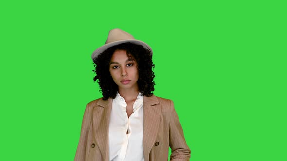 African American Woman in a Hat Posing on Camera on a Green Screen Chroma Key alt