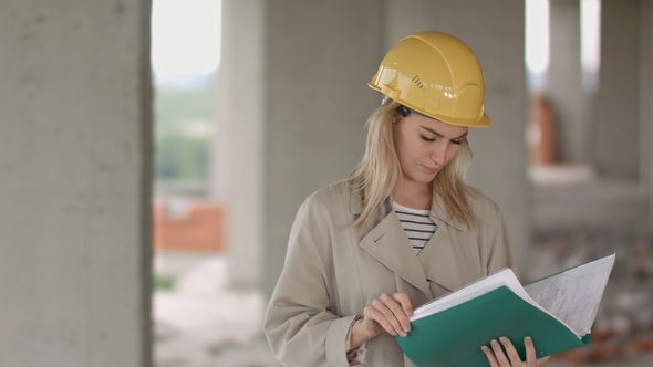 Young female architect construction engineer at a construction