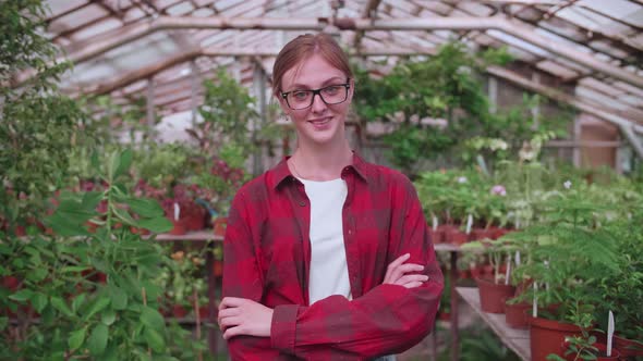 Portrait of a Young Worker of a Greenhouse in Which Flowers and Plants are Grown the Girl Inspector