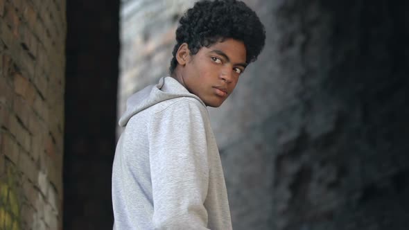 Lonely afro-american millennial walking abandoned place alt