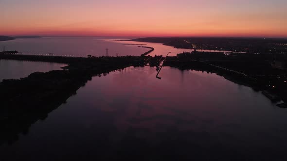 Aerial View. Sunset Over the Water Channel. In the Frame, a Dam or Bridge Is Strong. The Dam Covers alt