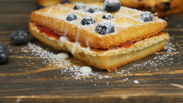 Zoom Belgian Waffle with Condensed Milk Blueberries and Powdered Sugar