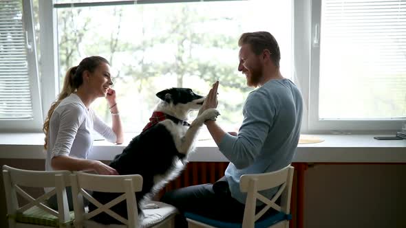 Beautiful Couple Relaxing at Home and Loving Their Dog