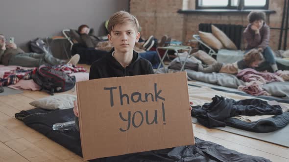 Boy with Thank You Sign in Refuge alt