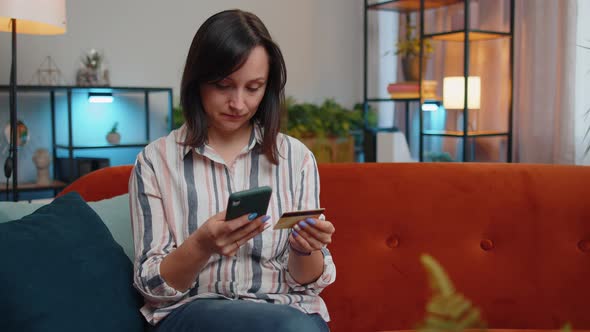 Young Woman Using Credit Bank Card and Smartphone Transferring Money Purchases Online Shopping alt