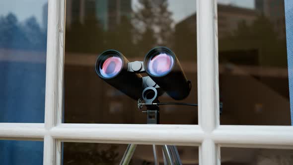 Binoculars in a window. Spying technology. Spy gear. Observation equipment. alt