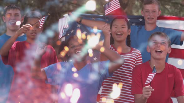 Kids watching fireworks and waving flags on Fourth of July