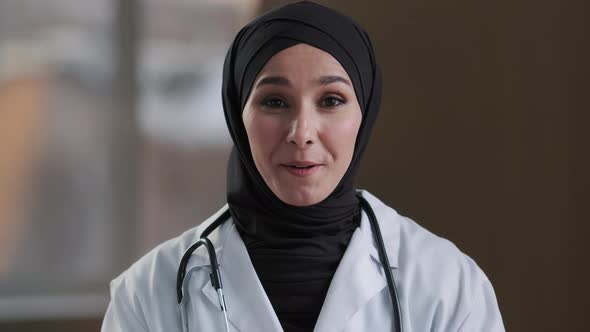 Happy Muslim Islamic Woman Doctor Arabian Girl Female Practitioner Adviser in Hijab Look at Webcam alt