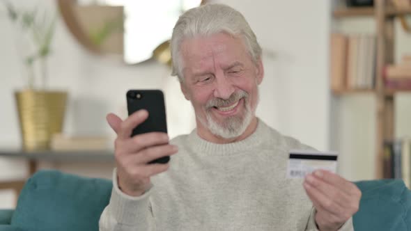 Excited Old Man Enjoying Online Shopping on Smartphone alt
