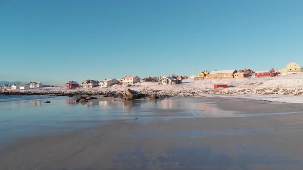 Ramberg village in the lofoten island, filmed from the beach during winter during a sunny day.