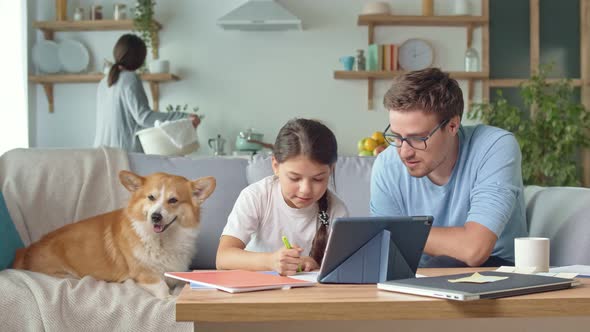 The Parent Explains the Daughter's Distance Learning at Home. alt