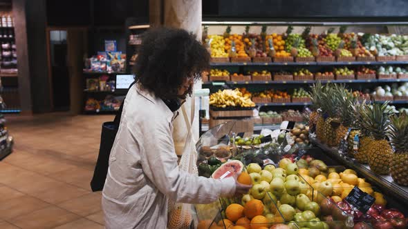 Afro American Female with Eco Bags and Headphones on Neck alt