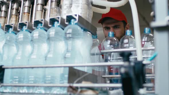 Water Bottles Moving on Automatic Conveyor Line in Water Production Factory
