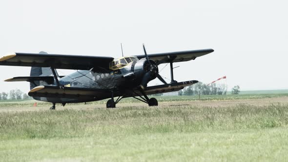 Small Old Propeller Plane is Moving Towards the Runway in Field for Takeoff alt