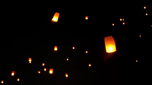 Blurry focus, Floating lanterns in the night sky.