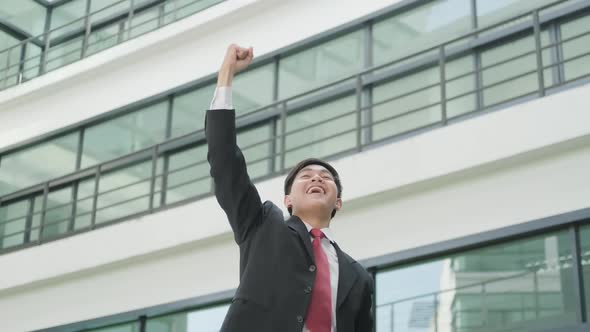 Happy businessman cheering excited in celebration after good news. alt