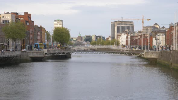 Millenium And Ha'penny Bridge Over Calm Water Of Liffey River From Grattan Bridge In Dublin, Ireland alt