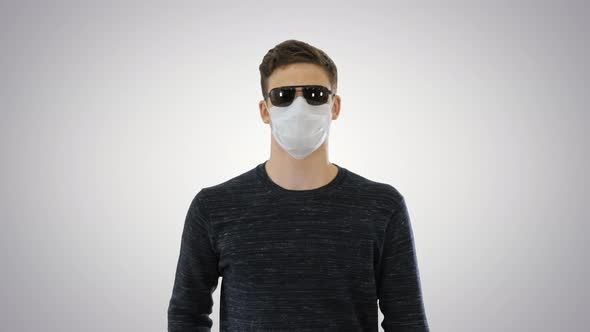 Blind Man in Face Mask and in Dark Glasses with Walking on Gradient Background alt