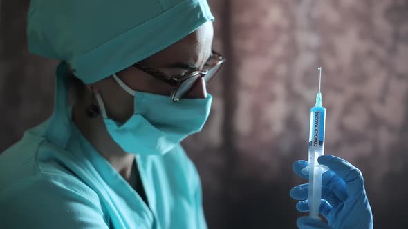 Doctor holding a syringe with the coronavirus COVID-19 vaccine