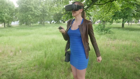 Sexy Young Girl Uses A Modern Helmet Of Virtual Reality On The Nature