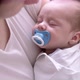 Little Newborn Baby Boy Sleeping with Baby Dummy on Mother Hands at Home Mom Puts Baby to Sleep - VideoHive Item for Sale