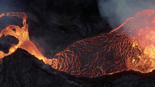 Top Down View Of An Active Lava River Flows From A Volcanic Eruption - aerial shot alt