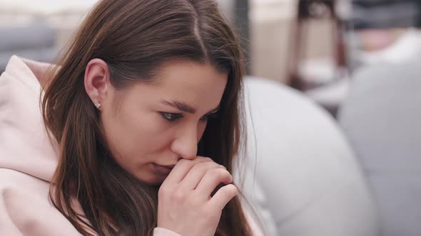 Bad Looking Woman Is Checking Something in a Laptop Sitting on a Couch