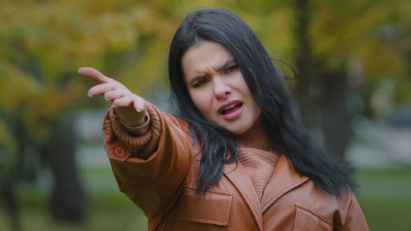 Young Frustrated Hispanic Woman Points with Palm Direction to Camera Says Hey you Insistently alt