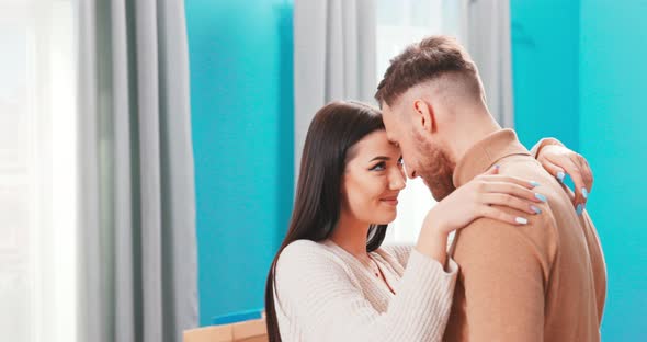 Happy Young Caucasian Couple Renters Hug Embrace Look in Eyes Relax on Romantic Weekend in alt