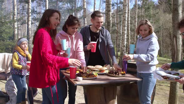 Young Beautiful Friends Have Fun Enjoying Bbq Party, Eating at Barbecue Outdoors