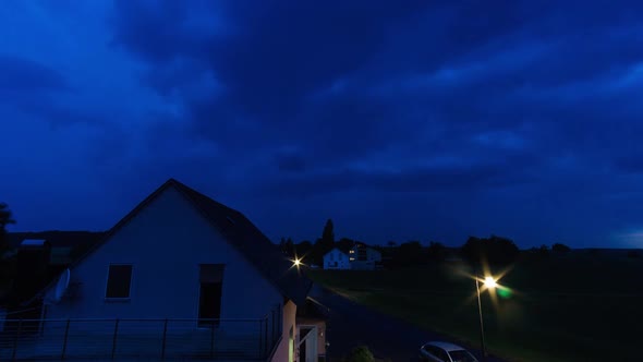 Thunderstorm cloud movement in summer over village street