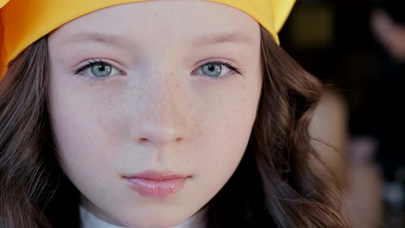 Beautiful little girl in a yellow hat. Shooting close up alt