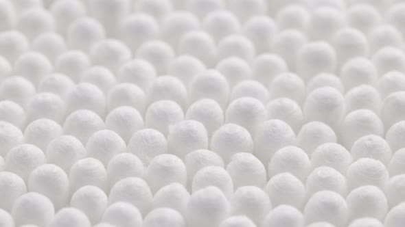 Closeup Spinning Fullframe Macro Background of Cotton Earbud Heads alt