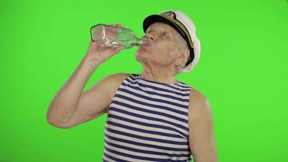 Elderly Sailor Man with Mustache Drinks Vodka, Old Sailorman on Chroma Key alt