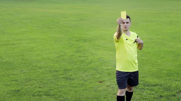 Soccer referee shows yellow card . Concept of sport, rules violation, offside. alt
