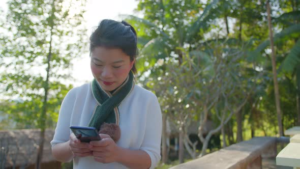 happiness asian female woman hand use smartphone to texting