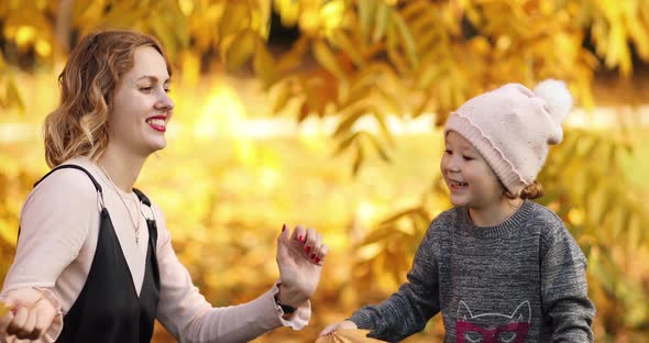 Young Light Haired Woman Playing with Her Lovely Child