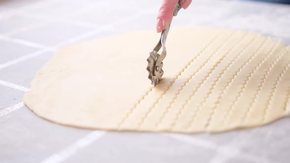 Apple Pie Cake Preparation Series  Woman Slicing Rolled Dough with Rolling Knife alt