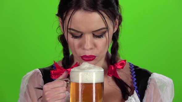 Girl Blowing in Glasses with Beer Bites His Lip. Slow Motion alt