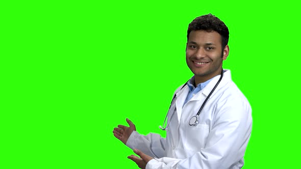 Smiling Doctor Showing Copy Space with Hands alt