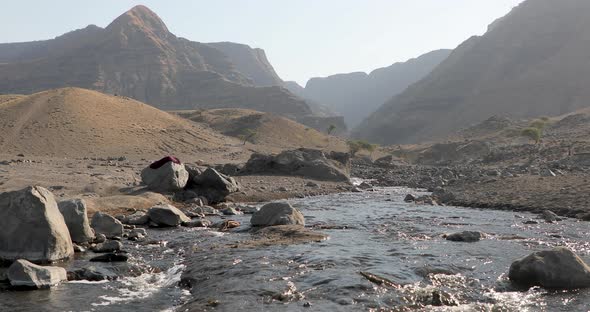 Mountain River Whose Water Runs Between the Trees on the Rocks and Cliffs alt