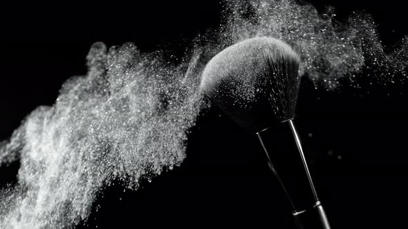 Super Slow Motion Shot of Silver Makeup Powder Falling From Facial Brush at 1000Fps alt