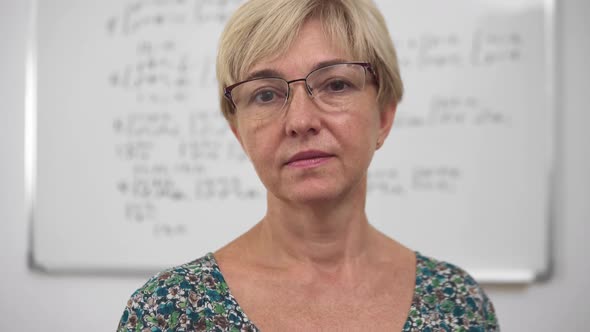 Aged Concentrated Blonde Woman Lecturer in Glasses Front Portrait