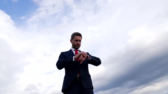 Punctual Professional Man Check Watch in Cloudy Sky Waiting