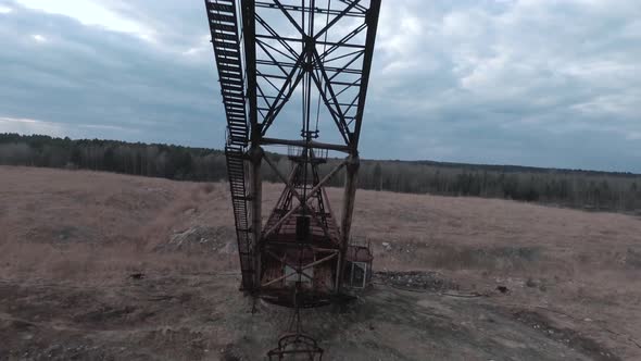 FPV Drone Flies Maneuverable Near Rusty Abandoned Walking Excavator alt